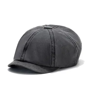 Detailed close-up of dark charcoal washed cotton newsboy cap with eight-panel stitching