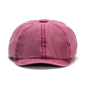 Close-up of burgundy washed cotton newsboy hat showing fabric texture and crown button
