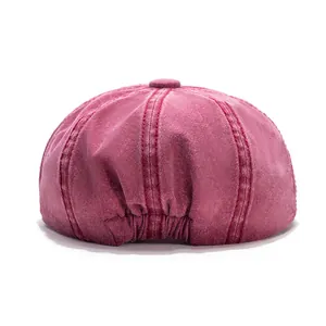 Close-up of vintage burgundy cotton newsboy cap featuring detailed stitching and elastic band