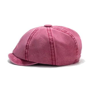 Detail of burgundy cotton newsboy cap showing fine stitching and corduroy texture