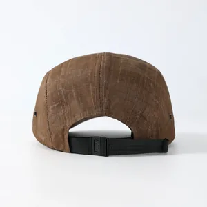 Rear view of brown plaid five-panel cap showing adjustable black strap and buckle