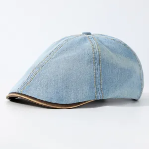 Light blue denim beret cap with yellow stitching and brown leather-trimmed brim