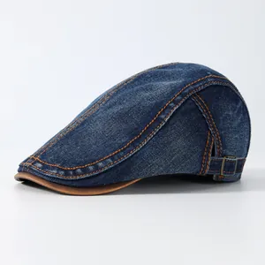 Vintage marine denim baret met oranje stiksels en bruin lederen klep detail
