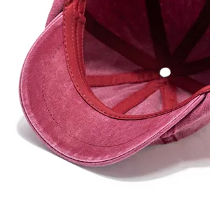 Macro shot of the burgundy washed cotton lining and stitching inside the octagonal cap