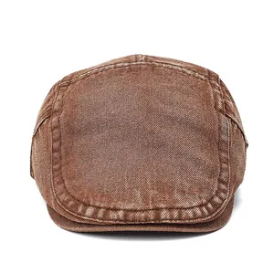 Detail shot of vintage brown washed denim newsboy cap featuring retro texture and stitching