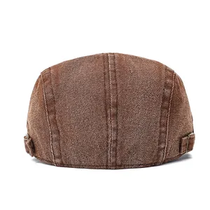 Detail view of the back of a vintage brown newsboy cap with metal adjustment buckles