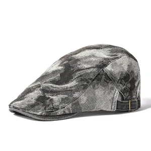 Vintage tie-dye denim ivy cap with adjustable brass buckle on white background