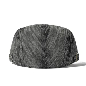 Detail view of washed denim ivy cap with vintage metal adjustment buckle and twill fabric