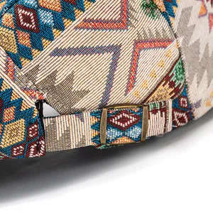 Detail of bohemian jacquard fabric on retro beret with vintage bronze metal buckle
