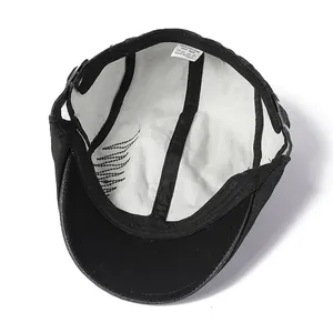 Detail view of cotton flat cap interior with quality stitching and 100% cotton label