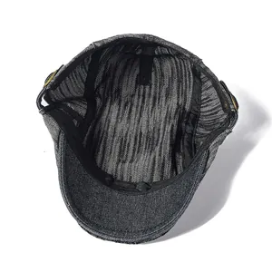 Detail of vintage denim ivy cap featuring internal sweatband and bronze metal buckle
