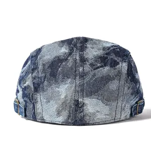Rear view of washed denim flat cap showing metal side buckles and stitching details