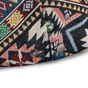 Macro detail of colorful geometric woven fabric and vintage metal button on the beret