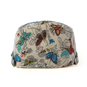 Macro shot of ethnic retro jacquard flat cap with colorful butterfly patterns and metal buckle