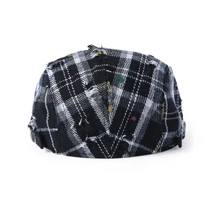 Vintage distressed plaid beret hat with colorful paint splatters and fringe details