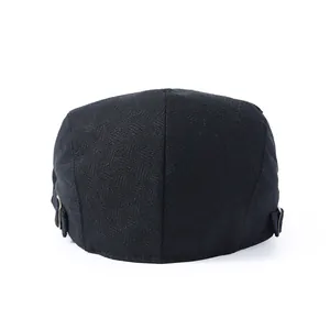 Close-up of black herringbone beret with adjustable side metal buckle detail
