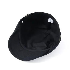 Detail of black beret interior featuring diamond-weave brim and 65% cotton fabric label