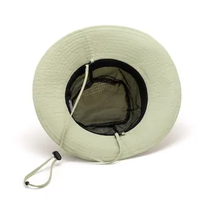 Detail of light green sun hat with breathable mesh lining and adjustable chin strap