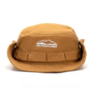 Detail of embroidered outdoors mountain logo on a khaki tactical bucket sun hat