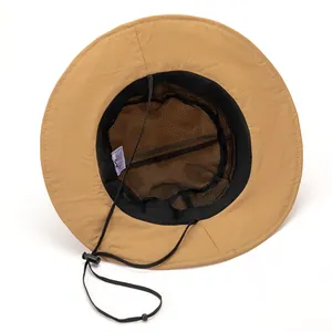 Detail of khaki sun hat featuring breathable black mesh lining and adjustable chin strap