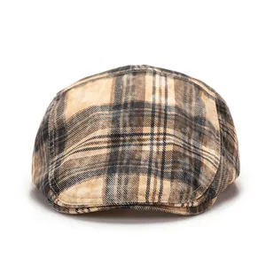 Close-up of British retro brown plaid fabric texture on a vintage newsboy beret hat