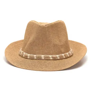 Detail of a brown straw fedora featuring a rustic rope band and breathable woven texture