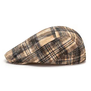 Close-up of the vintage brown plaid pattern and fine stitching on this stylish flat cap