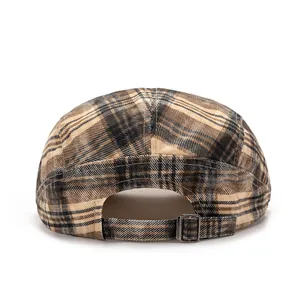 Detail of colorful plaid beret featuring an adjustable metal buckle on the back strap