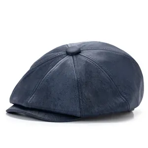 Detail of navy blue vintage newsboy cap showing textured faux leather and fine stitching