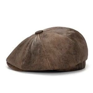 Detail of vintage brown newsboy cap showing octagonal stitching and leather texture