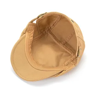 Detailed interior view of khaki cotton flat cap with metal buckle and reinforced seams