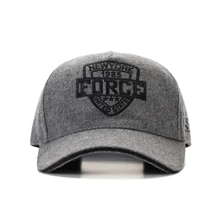 Close-up of the grey wool baseball cap showing detailed shield embroidery and texture