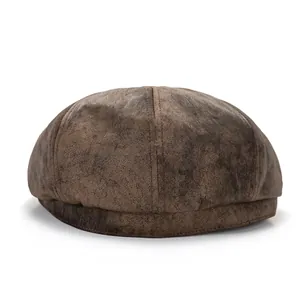 Detailed view of the textured distressed brown leather stitching on this newsboy cap