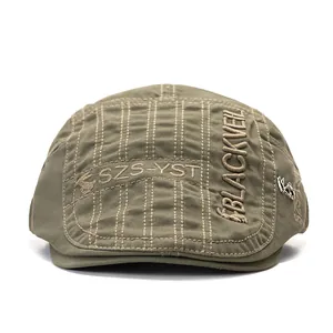 Detail of olive green beret showing fine stitching and silver metal pony emblem