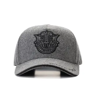 Deep grey thick wool baseball cap with shield embroidery on white background
