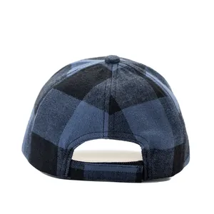 Detail view of the back adjustment strap on a blue plaid wool baseball cap with stitching