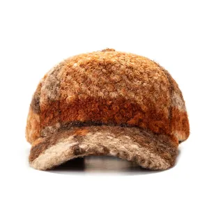 Plaid woolly baseball cap for winter in warm brown and orange tones on white background