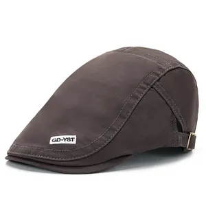 Detail of dark brown cotton canvas ivy cap with metal buckle and woven logo patch
