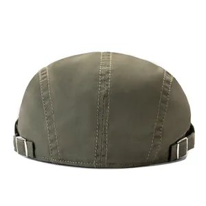 Detail of army green docker cap featuring durable canvas fabric and adjustable metal side buckles