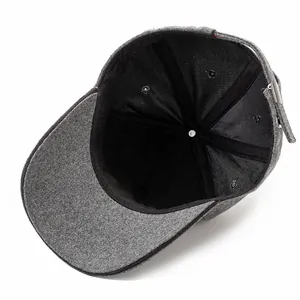Detail of adjustable metal buckle and stitching on dark gray wool baseball cap