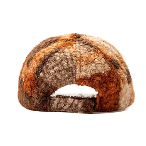 Macro shot of the plush faux fur texture and adjustable strap on back of the plaid baseball cap