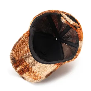 Detail of plaid wool baseball cap showing inner mesh lining and premium texture