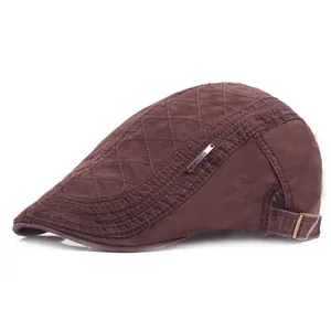 Detail of dark brown beret with diamond quilting and adjustable metal side buckle