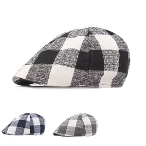 Detail view of vintage plaid beret hats in black, blue, and grey cotton linen fabric