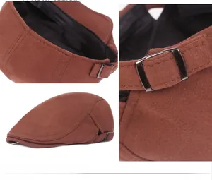Detail view of the rust red wool beret showing stitching and adjustable metal buckle