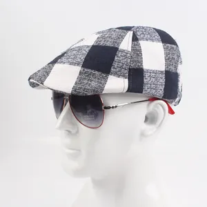 Detail of a black and white checkered ivy cap featuring a coarse woven texture fabric