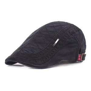 Detail of black beret featuring quilted diamond patterns and adjustable side metal buckle