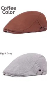 Detail of wool beret flat caps in coffee and light grey with adjustable metal buckle straps