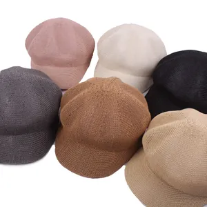 Flat lay detail showing six colors of breathable woven newsboy caps for summer sun protection