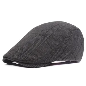 Detail of dark grey plaid pattern on the cotton beret showing texture and fine stitching